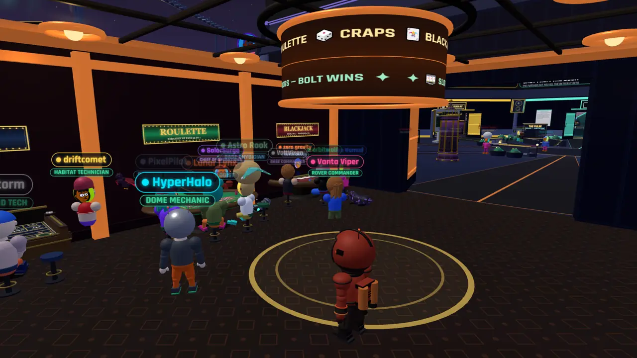The casino floor with members seated at blackjack, roulette and craps tables under a lit board